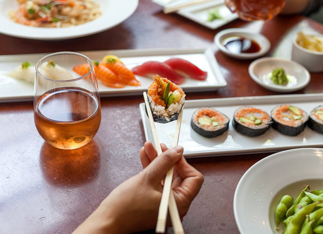 Sushi and maki rolls being enjoyed with chopsticks at Kabuki